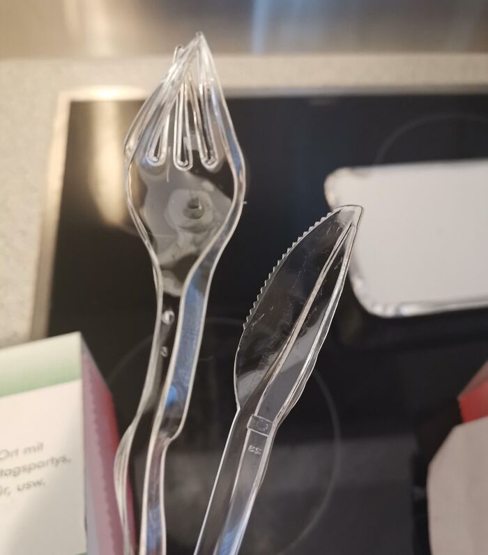 Clear plastic spork and plastic knife set, illustrating unusual packaging and delivery mishaps with fragile items.