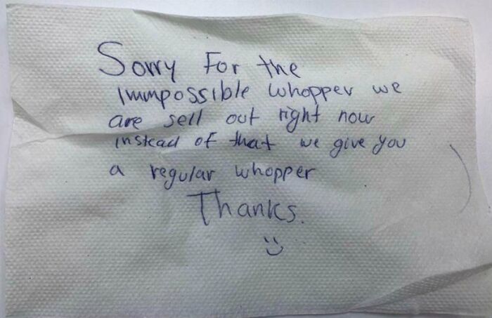 Handwritten note on napkin apologizing for missing item in delivery, showing an unfortunate delivery mistake.