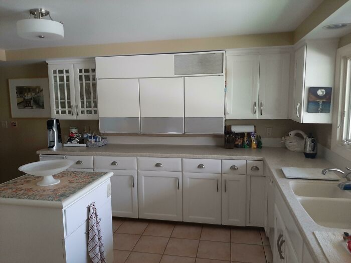 1950s vintage kitchen with white cabinets, tiled floor, and retro appliances capturing essence of life in the 1950s.