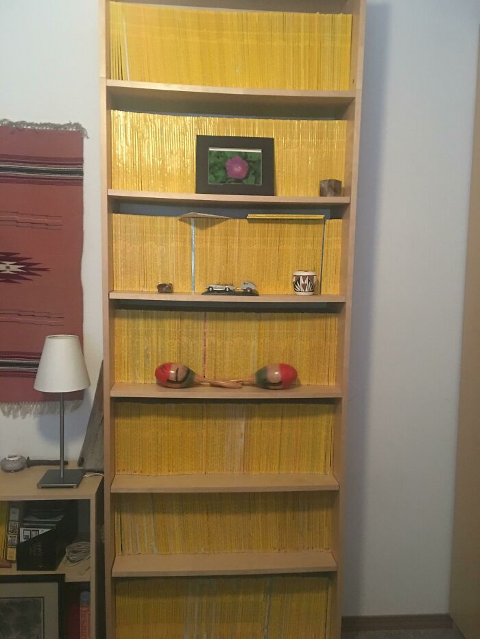 Bookshelf filled with vintage yellow magazines and nostalgic 1950s items capturing the essence of life in the 1950s.