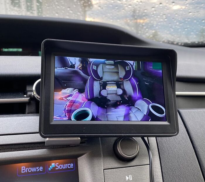 Car accessories featuring a digital screen showing a child car seat, ideal for passenger seat storage solutions.