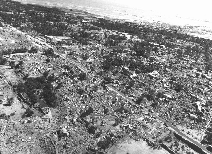 Aerial view of extensive destruction after a major natural disaster showing ruins and debris over a large area.