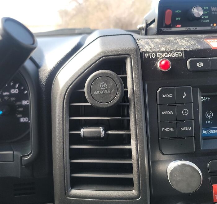 Car accessories installed on a vehicle dashboard and vent, ideal for passenger seat storage organization.