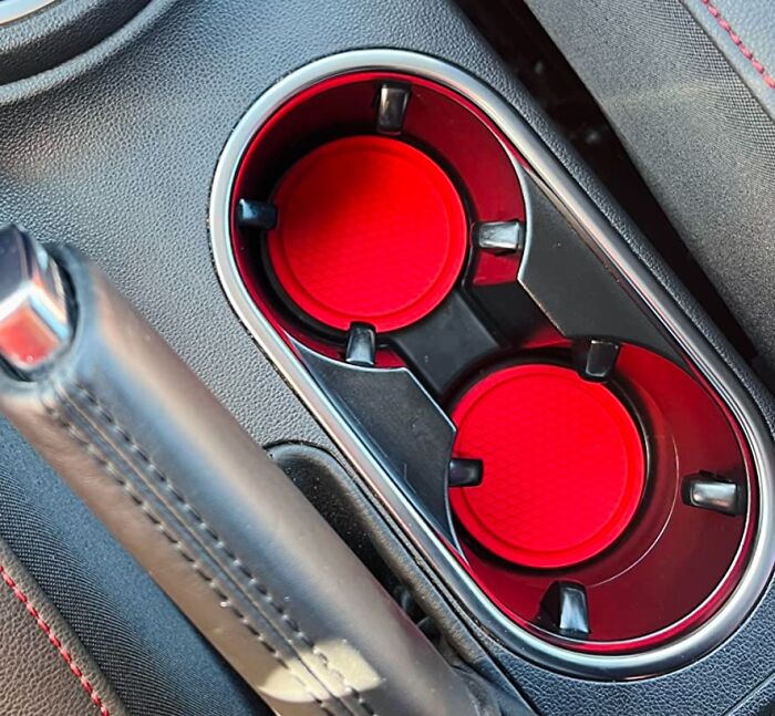 Car accessories cup holder inserts in a vehicle center console, ideal for passenger seat storage organization.