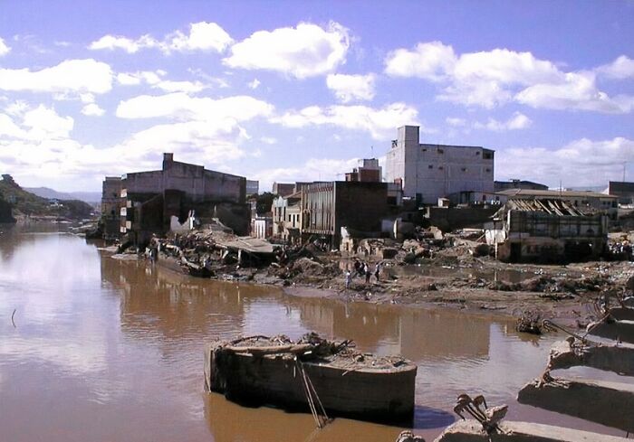 Flooded town with damaged buildings and debris after a natural disaster, illustrating the impact of major natural disasters.