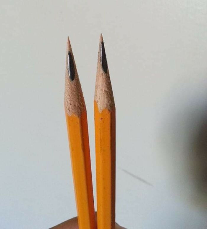 Two imperfectly sharpened pencils held side by side showing uneven tips, illustrating imperfection and OCD annoyance.