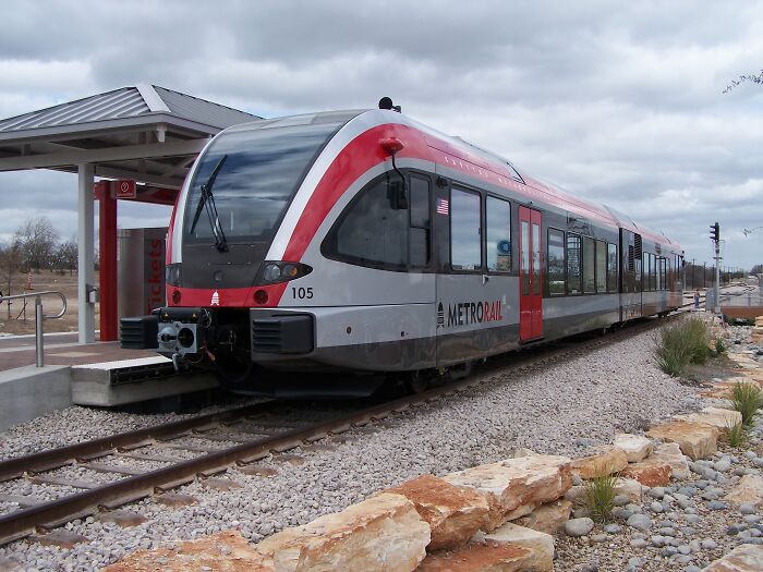 Modern MetroRail train at a station with rocky terrain, representing the best places to live in the USA for settling down