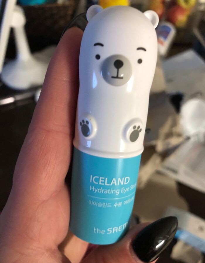 Hand holding quirky polar bear eye stick, a fun and unusual skincare find to delight your weird little heart.