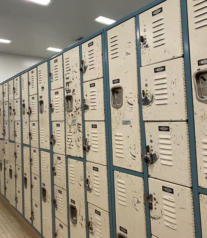Worn and rusty school lockers in a hallway, illustrating not all schools are created equal in condition and upkeep.