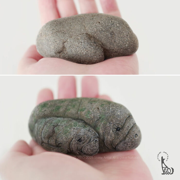 Hand holding stones transformed by Japanese artist into adorable animals with detailed features and natural textures.