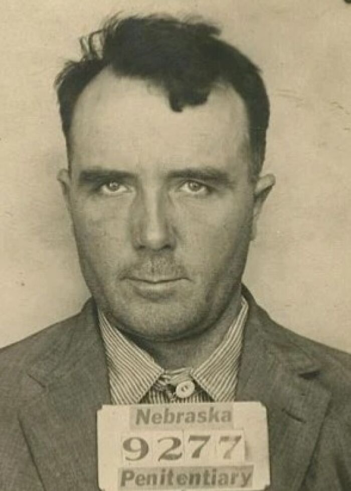 Vintage historical mugshot of a man from Nebraska Penitentiary captured in black and white photograph.