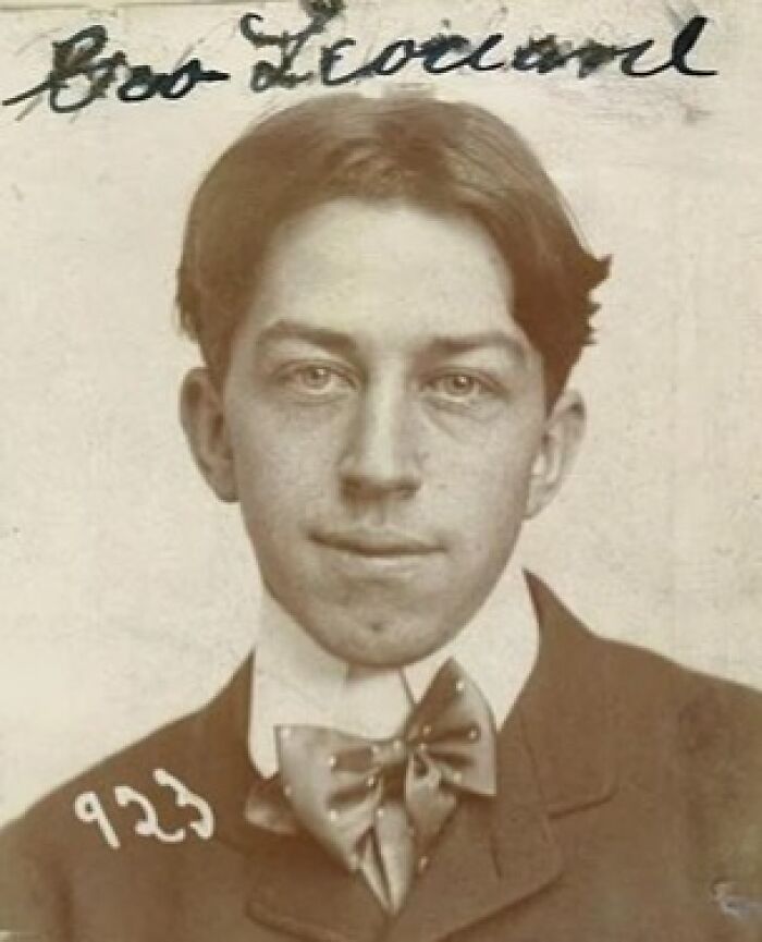 Vintage historical mugshot of a young man wearing a bow tie, part of intriguing stories behind historical mugshots.