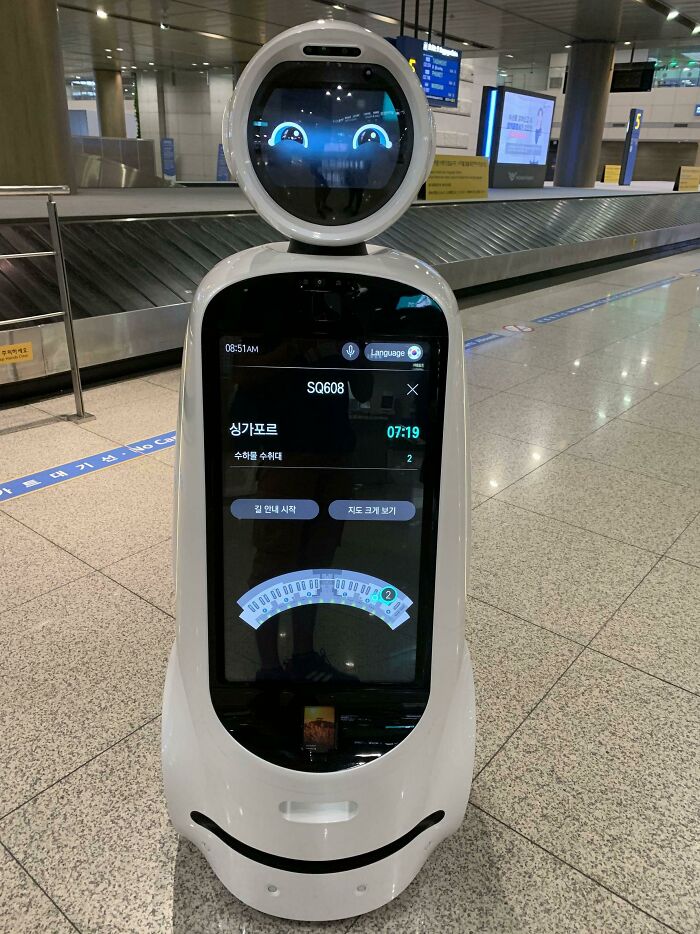 Smart airport robot with digital screen showing flight info, offering genius solutions to overlooked travel problems.