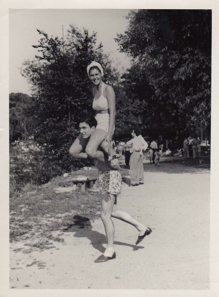 Couple playing outdoors in the 1950s wearing vintage swimwear, capturing the essence of life and fun moments.