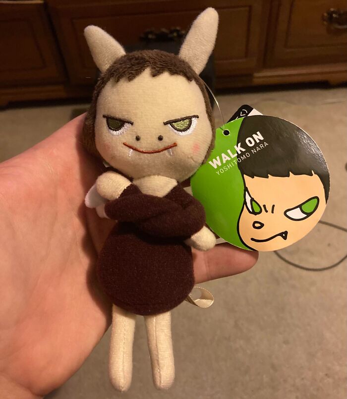 Plush toy with crossed arms and a mischievous face, held in hand, illustrating hilarious dads nailing fatherhood.