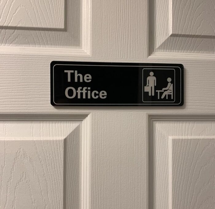 Black sign reading The Office with icons of people on a white door, a novelty find that gives a dopamine hit.
