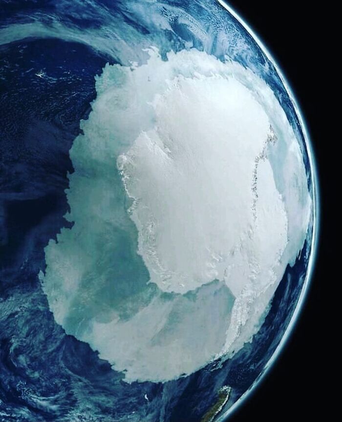 Satellite view of Antarctica showcasing icy landmass and surrounding ocean in a fascinating world geography photo.