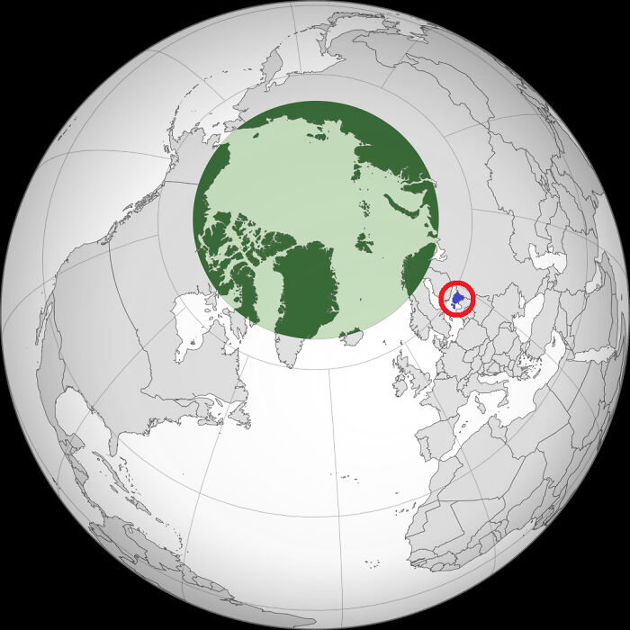 Globe map highlighting a specific region with a green circle and red marker, showcasing world geography details.