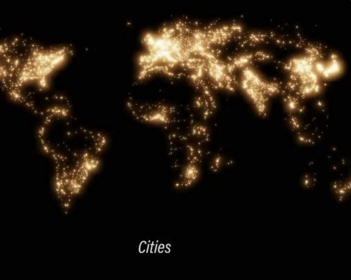 World geography map illuminated with glowing city lights highlighting major urban areas across continents.