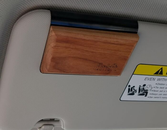Wooden car sun visor organizer mounted, one of the most-wished-for Amazon finds for stylish vehicle storage.