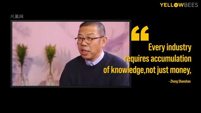 Man wearing glasses and a sweater discussing wealth and knowledge in relation to the richest people in the world.