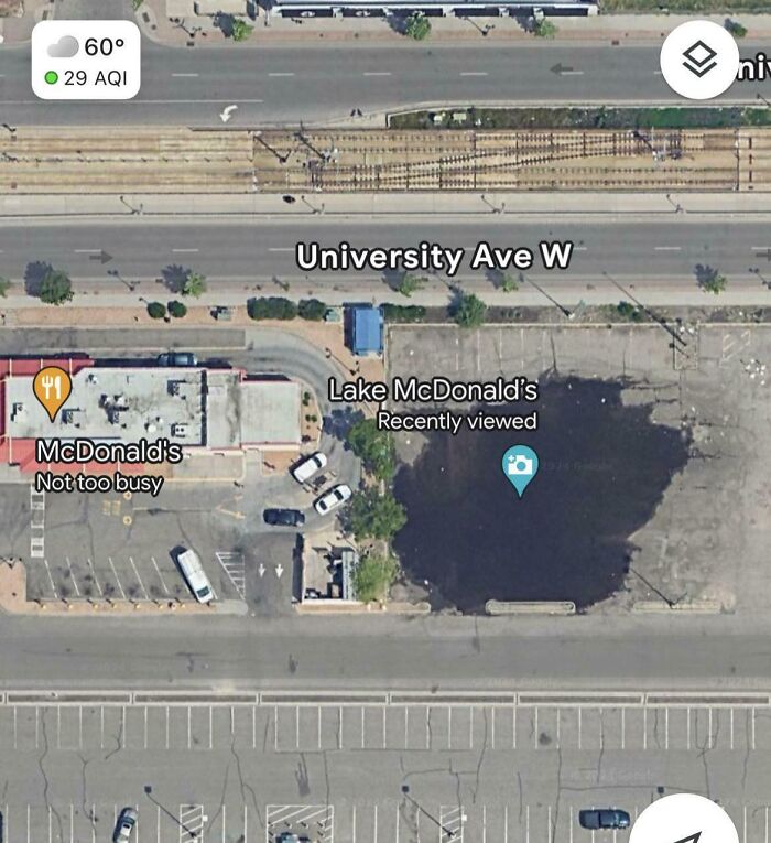 Aerial view of a parking lot and buildings near University Ave W showcasing unique world geography features.