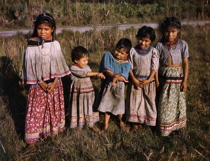 Five children in traditional dress standing outdoors in 1950s Florida, capturing everyday life in the era.