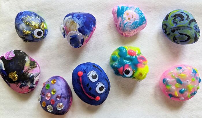 Colorful painted rocks with googly eyes and decorations, showcasing creative toys under $20 for gifting ideas.