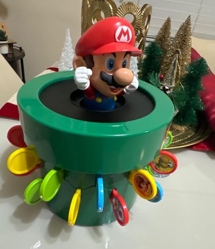Mario pop-up toy with colorful flaps on a green base, one of the top toys under $20 for gifting genius ideas.