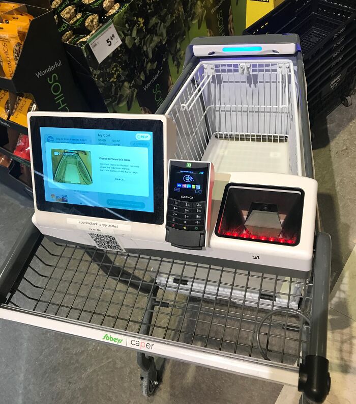 Self-checkout shopping cart with touchscreen and payment terminal offering a genius solution to overlooked retail problems