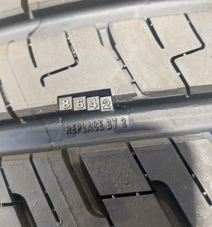 Close-up of a tire tread wear indicator showing replacement suggestion for a genius solution to overlooked problems.