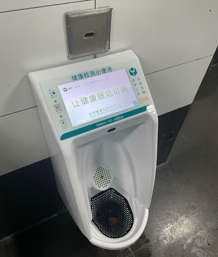 Urinal with built-in health testing display screen offering innovative solutions to overlooked hygiene problems in public restrooms.