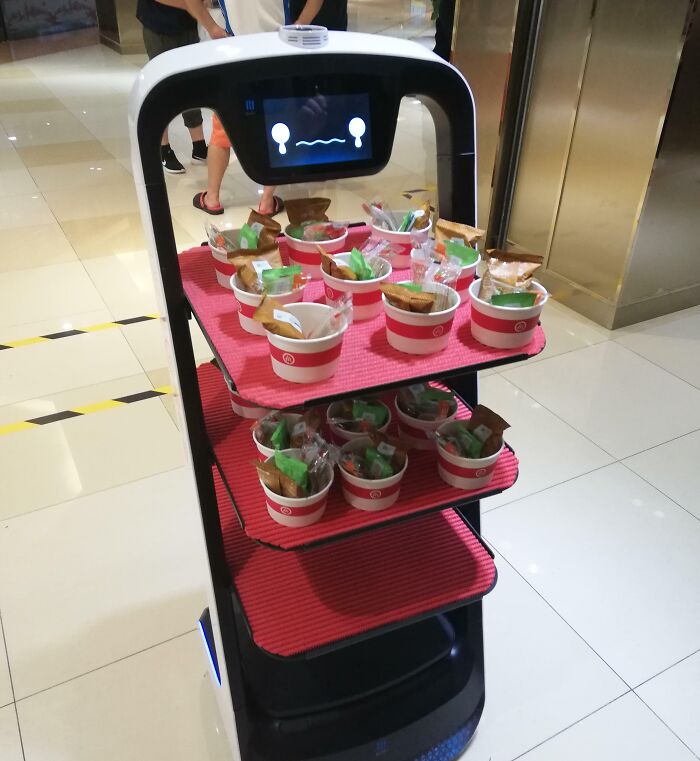 Robot food delivery in a shopping mall showcasing a genius solution to overlooked problems with automated service innovation.