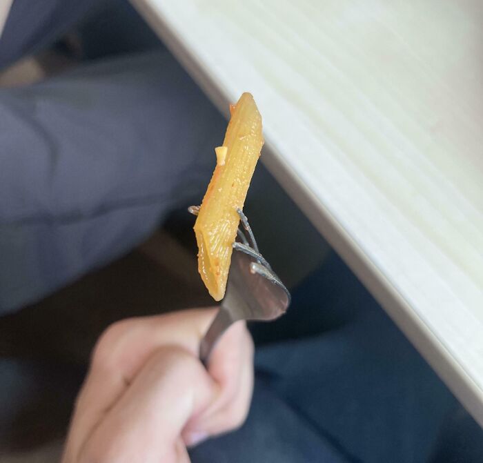 Close-up of a small piece of pasta on a fork, illustrating unusual school lunch conditions in schools not created equal.