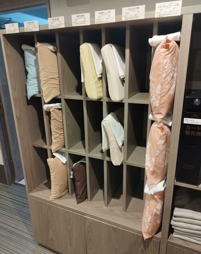 Various uniquely shaped pillows neatly organized on wooden shelves as a genius solution for better sleep comfort.