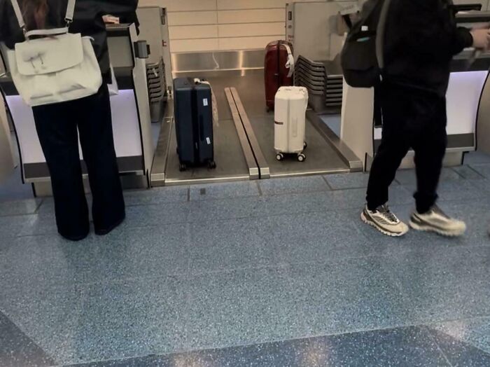 Travelers placing suitcases on airport conveyor belt, demonstrating genius solutions for overlooked travel problems.