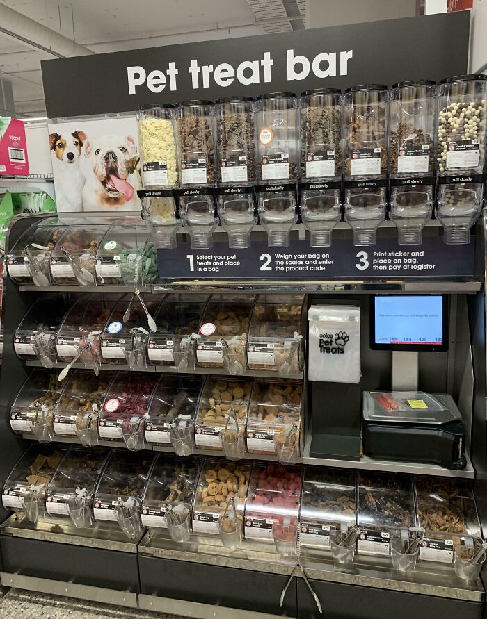 Pet treat bar with various bulk dog treats and a weighing station for selecting and buying pet snacks.