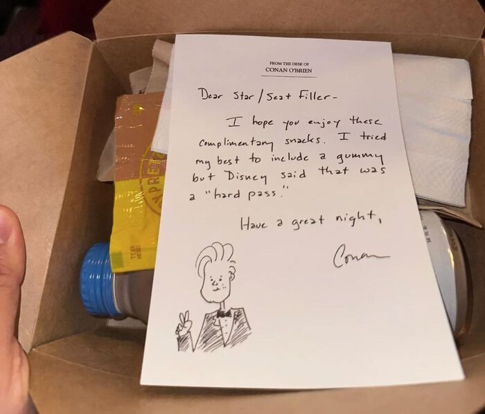 Handwritten note on a box of snacks with a cartoon drawing, showing the beauty of planet Earth through simple kindness and care.