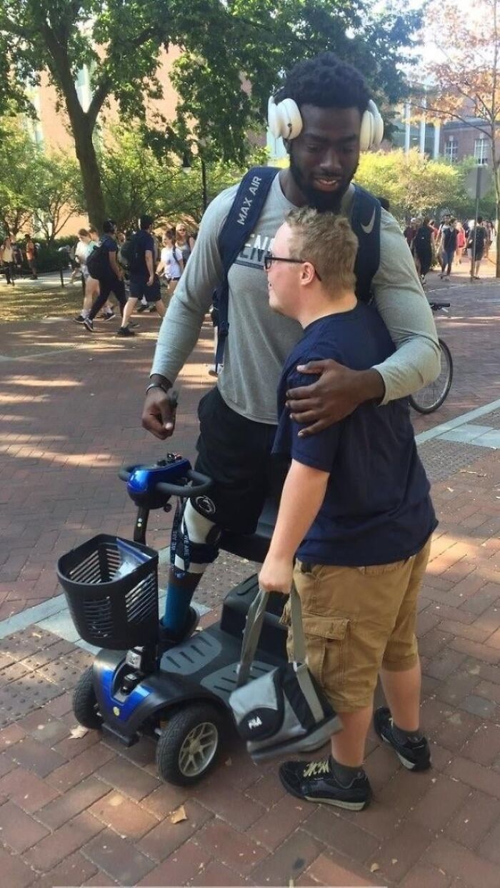 Two people sharing a warm hug outdoors, showcasing the beauty of planet Earth in a wholesome moment.