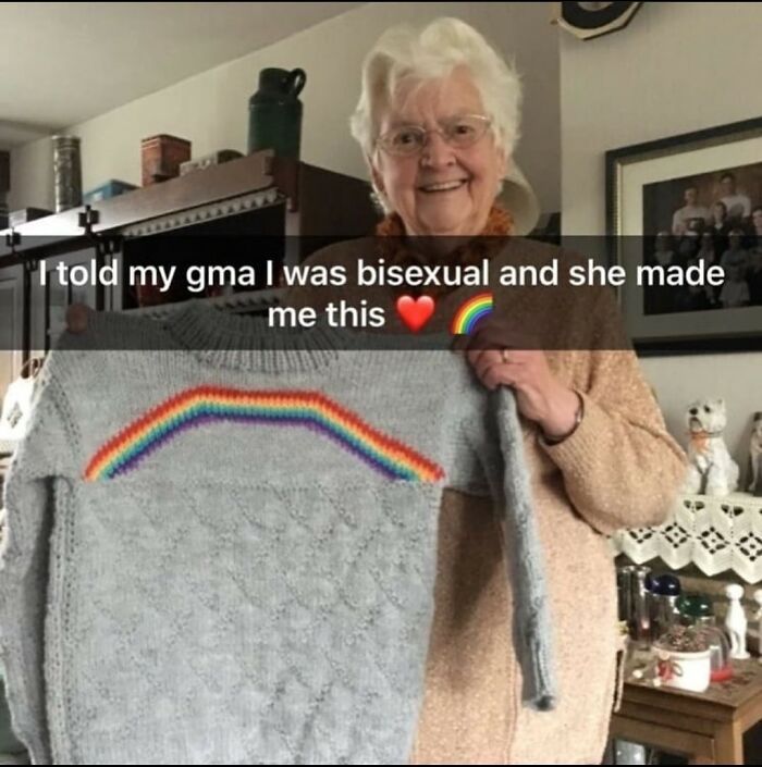 Elderly woman holding a knitted sweater with a rainbow design, representing the beauty of planet earth and love.