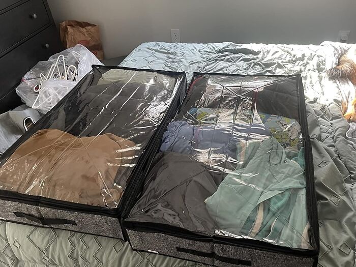 Two transparent storage containers on a bed used for hiding the ugliest eyesores in your home.