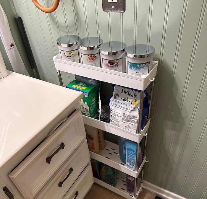 Compact storage rack in a bathroom corner organizing toiletries and hiding the ugliest eyesores in your home efficiently.