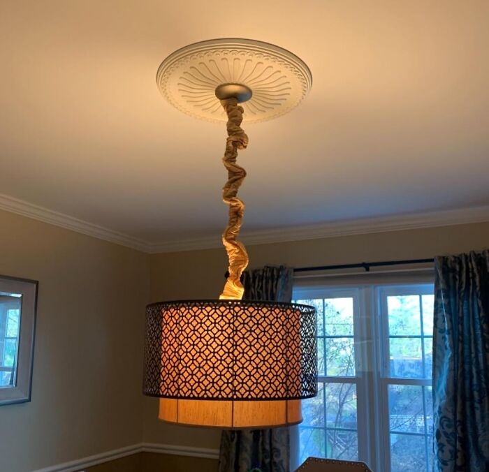 Pendant light fixture with fabric cord cover used to hide ugly eyesores in a home interior setting.