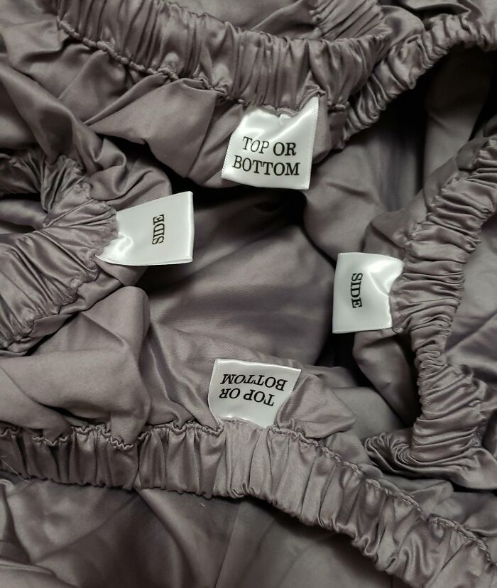 Fitted sheet with clear top, bottom, and side labels for easy bed making, a genius solution to overlooked problems.