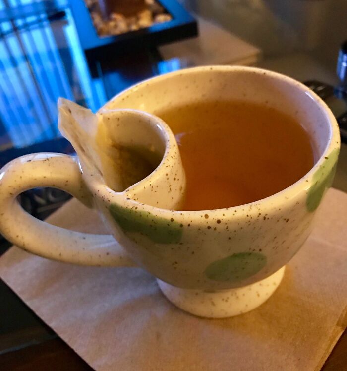 Ceramic tea cup with built-in tea bag holder, a genius solution to an overlooked problem in everyday tea drinking.