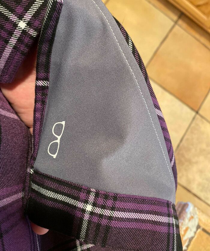 Close-up of a purple plaid shirt cuff featuring a built-in glasses holder as a genius solution to everyday problems.