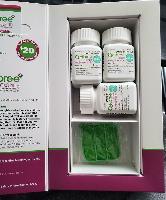 Medical bottles and capsules of Qelbree medication displayed in an open box for ADHD treatment in adults.