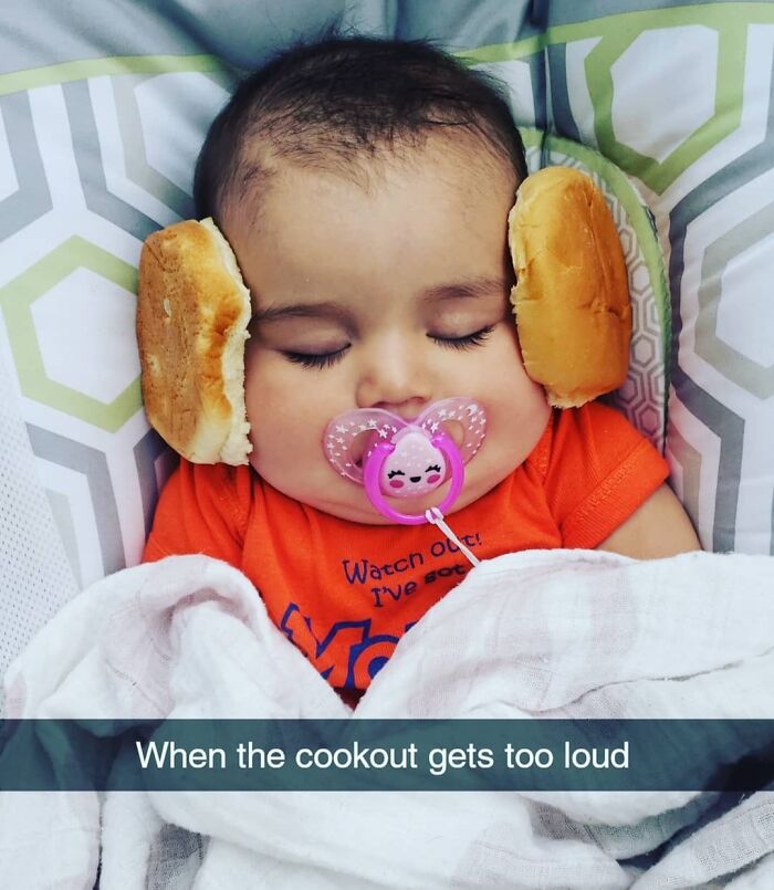 Sleeping baby with burger buns as headphones and a pacifier, showcasing hilarious dads nailing fatherhood humor.