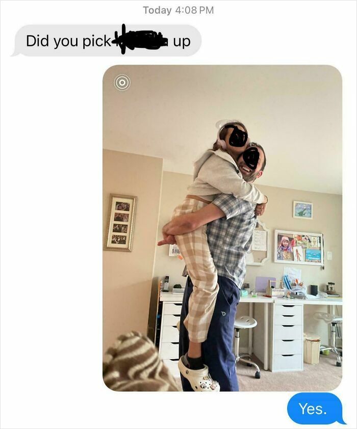 Dad lifting child in cozy home office setting showing hilarious dad moments nailing fatherhood with love and care.