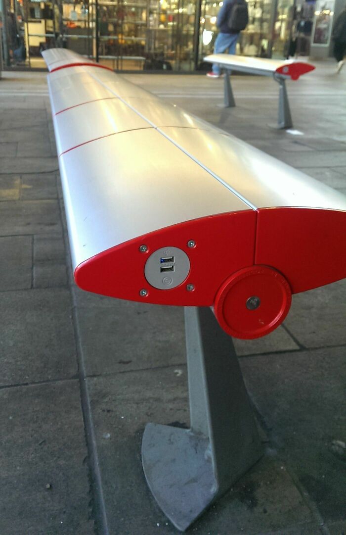 Outdoor public bench with built-in USB charging ports, showcasing genius small innovations some countries use worldwide